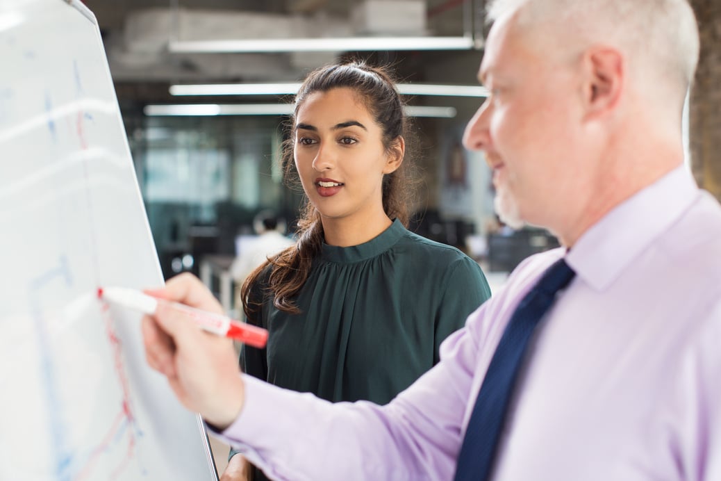 Senior Expert Explaining Diagram to Woman